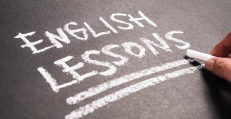 english-lessons-chalkboard-closeup-hand-writing-text-183431424